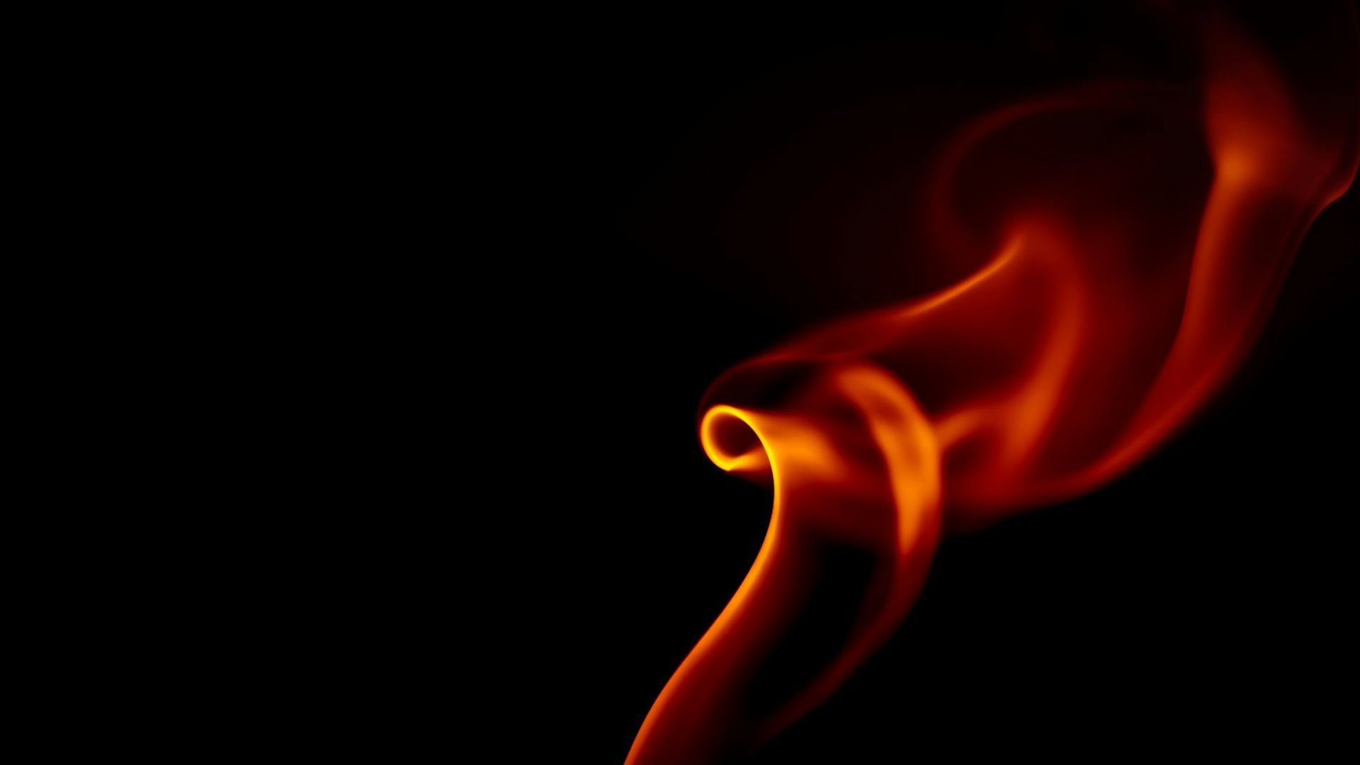 Abstract dark background with subtle orange light trails representing movement and energy.